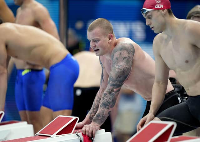 Britain's Adam Peaty, left, and James Guy look on after their team finished second in the mixed 4x100-meter medley relay. Picture: AP/David Goldman