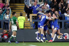 Leeds Rhinos' Harry Newman (centre right) celebrates scoring his side's fourth try of the game with team-mates and fans. Picture: PA.