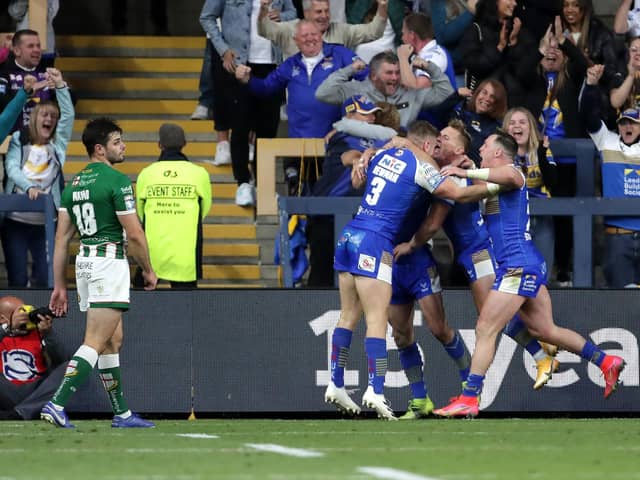 Leeds Rhinos' Harry Newman (centre right) celebrates scoring his side's fourth try of the game with team-mates and fans. Picture: PA.