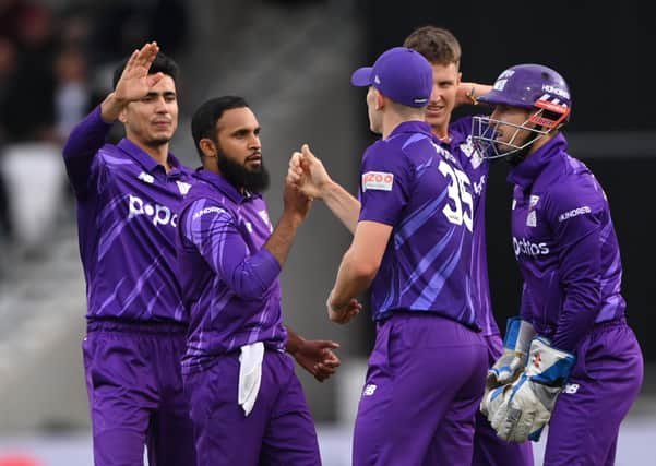 Superchargers bowler Adil Rashid (l) is congratulated after taking the wicket of Laurie Evans. (Photo by Stu Forster/Getty Images)