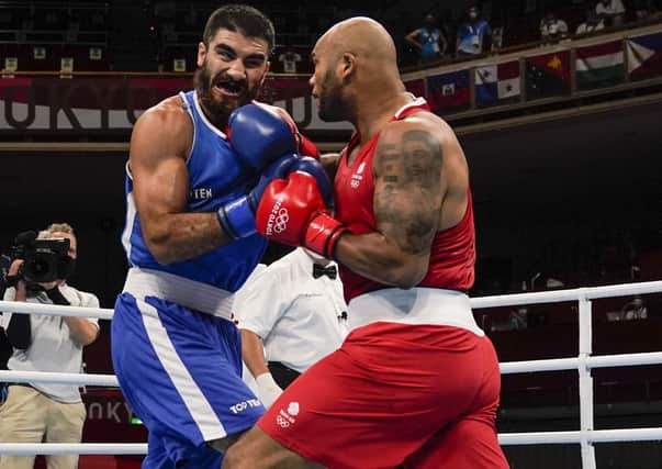 Controversy: Britain's Frazer Clarke punches Eliad Mourad, who was disqualified for a head-butt.