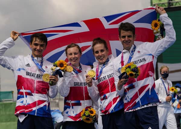 Great Britain celebrate its gold medal triumph in the mixed triathlon team relay.