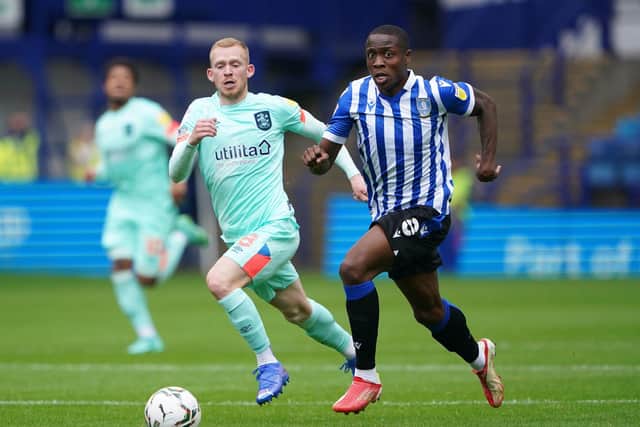 Sheffield Wednesday's Dennis Adeniran and Huddersfield Town's Lewis O'Brien battle for the ball at Hillsborough on Sunday. Picture: Zac Goodwin/PA