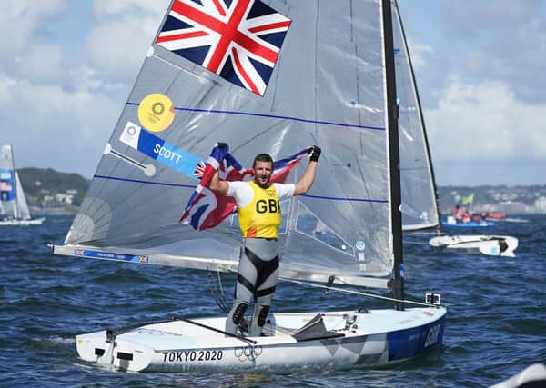 Victory: Britain's Giles Scott celebrates. Pictures: AP Photo/Bernat Armangue