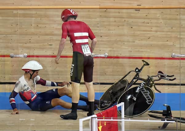 Down: Charlie Tanfield on the ground after being crashed into by Denmark's Frederik Madsen.
