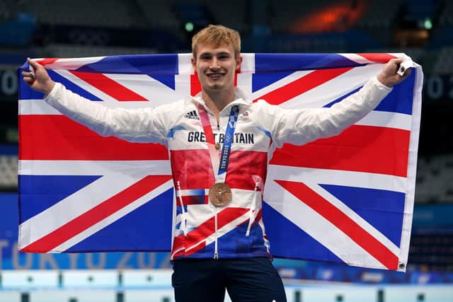JOB DONE: Jack Laugher celebrates on the podium with the bronze medal. Picture: Martin Rickett/PA