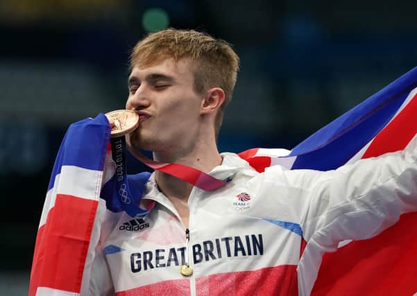 PODIUM KING: Jack Laugher celebrates on the podium with the bronze medal for the Men's 3m Springboard at Tokyo Aquatics Centre.. Picture: Martin Rickett/PA