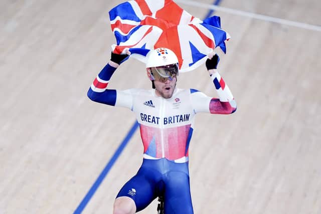 Flying the flag: Matthew Walls celebrates gold in the men's omnium points race.