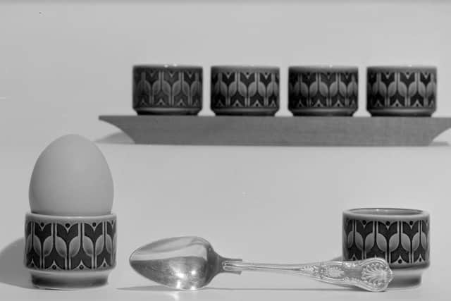 Heirloom egg cups on wooden stand