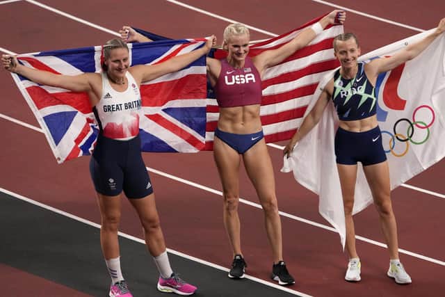 Gold medalist Katie Nageotte, centre, of the United States, poses for a photo after winning the final of the women's pole vault with second placed, Anzhelika Sidorova, right, of Russian Olympic Committee, and bronze medalist Holly Bradshaw, left, of Britain, at the 2020 Summer Olympics, Thursday, Aug. 5, 2021, in Tokyo. (AP Photo/Charlie Riedel)