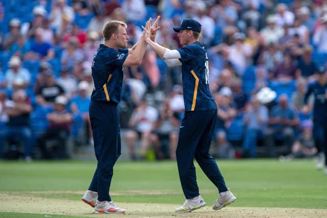 All-round effort: Matthew Waite, left, celebrates after taking Warwickshire's Rob Yates's wicket - caught by Gary Ballance for 11.
  Picture Bruce Rollinson