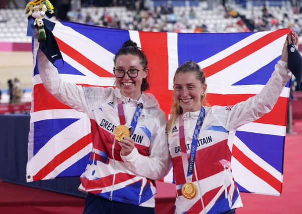 Great Britain's Katie Archibald (left) and Laura Kenny celebrate with their gold medals after winning the Women's Madison Final at the Izu Velodrome on the fourteenth day of the Tokyo 2020 Olympic Games in Japan.