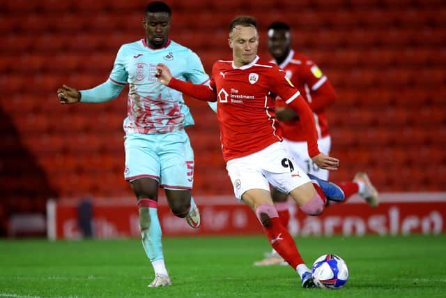 In charge: Barnsley's new captain, Cauley Woodrow, right, battle for the ball during the Championship play-off semi-final.