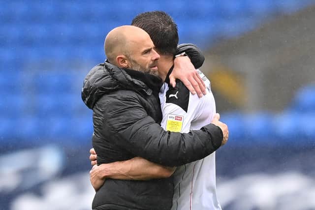 The agony or relegation: Paul Warne, manager of Rotherham United embraces Richard Woodafter the Championship match at Cardiff City. Picture: Justin Setterfield/Getty Images