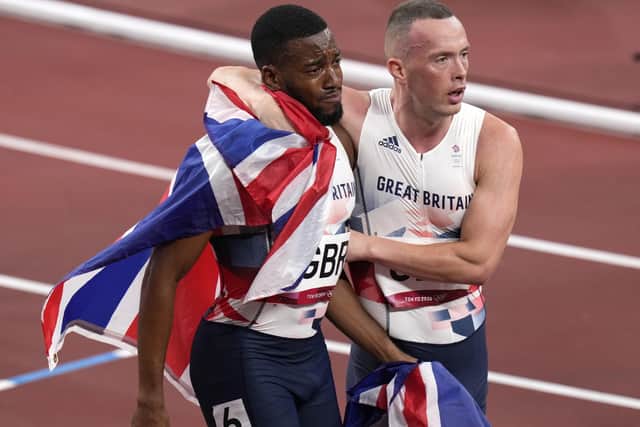 Middlesbrough's Richard Kilty, right, consoles Nethaneel Mitchell-Blake of Britain who reacts after anchoring his team to the silver medal in the final of the men's 4 x 100-metre relay at the 2020 Summer Olympics. (AP Photo/Francisco Seco)