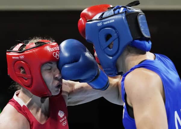 Britain's Lauren Price, left, is punched Netherlands' Nouchka Fontlijn during their women's middleweight 75-kg emifinal. (AP Photo/Themba Hadebe, Pool)