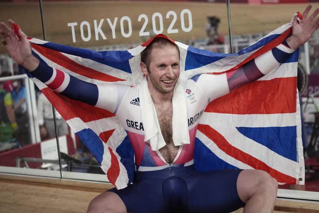 Flying the flag: Jason Kenny celebrates winning the gold medal in the track cycling men's keirin race.
