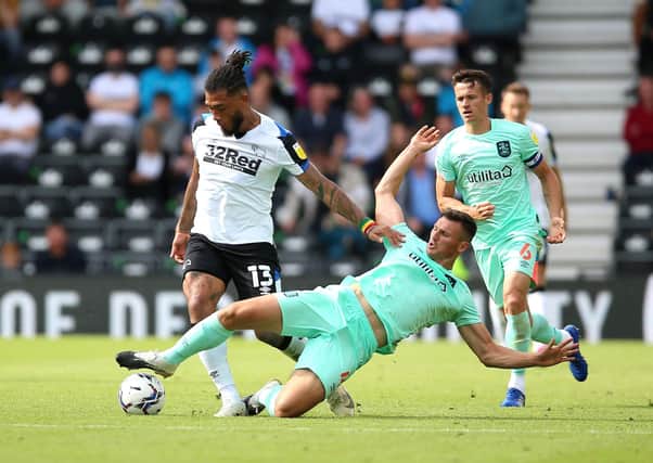 Timely tackle: Derby County's Colin Kazim-Richards is challenged by Huddersfield Town's Matthew Pearson.