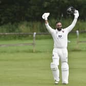 Century salute: North Leeds' 
Amir Farooq celebrates his century at  Horsforth in Division One of the Aire Wharfe League. He scored 106 off 71 balls including eight fours and seven sixes. Picture: Steve Riding