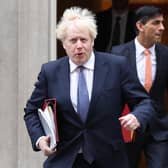 Boris Johnson and Rishi Sunak leave 10 Downing Street.