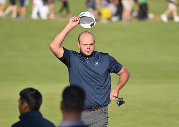 OPEN SNAPSHOTS: Jonathan Thomson of Rotherham takes the acclaim of the galleries after holing his tee shot on the par-three 16th. Picture: Getty Images.