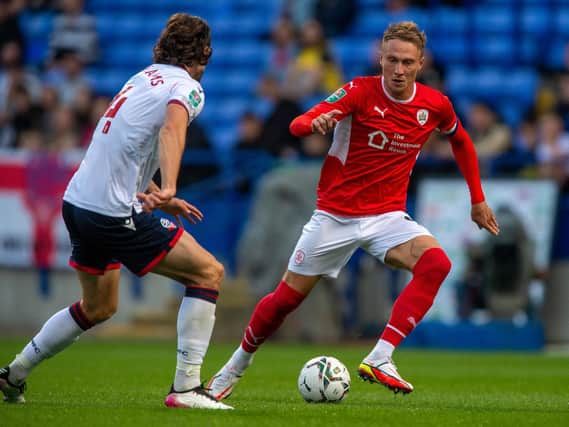 Barnsley captain Cauley Woodrow on the attack against Bolton's MJ Williams. Picture: Bruce Rollinson.
