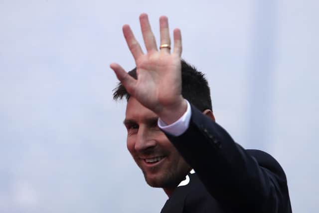 Glad to join you: Lionel Messi waves to Paris Saint-Germain supporters outside the Parc des Princes stadium. Picture: AP Photo/Rafael Yaghobzadeh