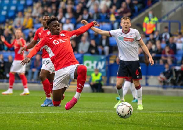 Disappointing: Barnsley striker Clarke Oduor gets a shot in against 
Bolton Wanderers.  Pictures: Bruce Rollinson