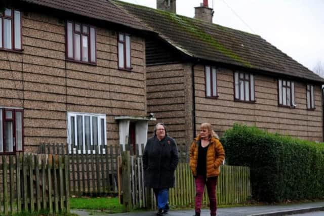 Cindy Readman (right) and Mavis Abbey walking outside the 1950s pre-fabricated homes in Oulton, which are due to be demolished and replaced