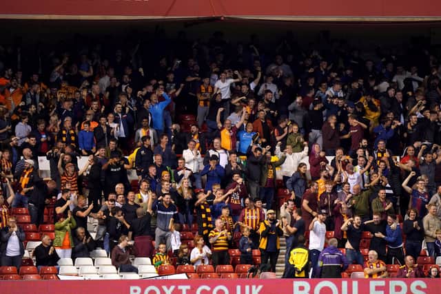 Bradford City fans in the stands celebrate their side's goal.