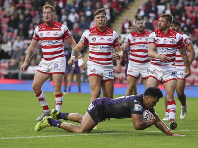 Watching on: Leeds forward Zane Tetevano goes through a static Leigh defence to score the first try. Picture by Paul Currie/SWpix.com