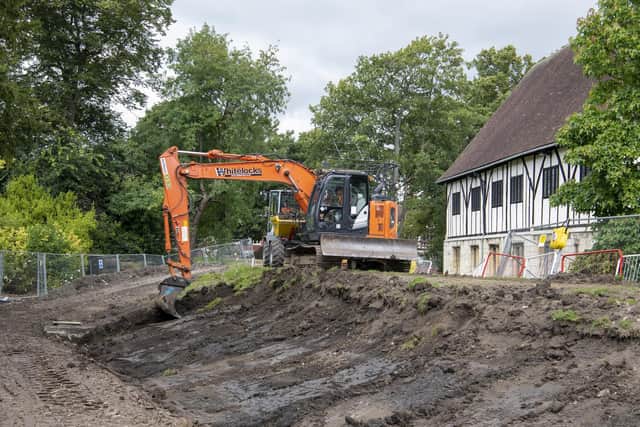 An excavator at work beside The Hospitium