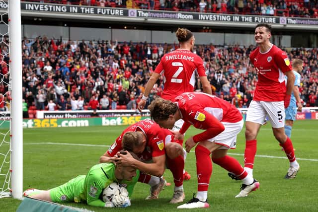 Barnsley goalkeeper Bradley Collins celebrates with team-mates after saving Coventry City's Viktor Gyokeres (not pictured) penalty kick (Picture: PA)