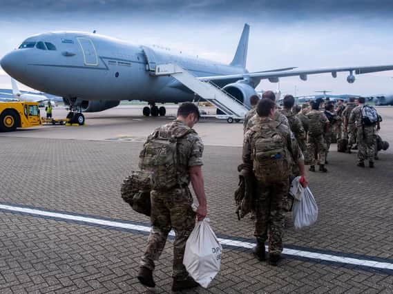 Some of the 600 British military personnel boarding a flight as members of all military three services and civilians deploy to Afghanistan as part of Operation Pitting to support the UK's withdrawal.