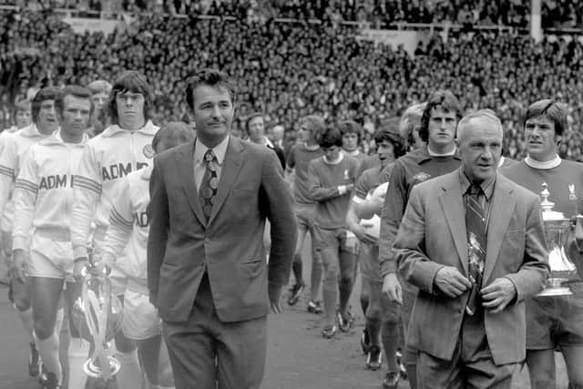The two managers, Leeds United's Brian Clough and Liverpool's Bill Shankly, lead their teams out onto the pitch as the captains, Leeds United's Billy Bremner and Liverpool's Emlyn Hughes, carry the trophies their teams won the previous season. (Picture: PA)