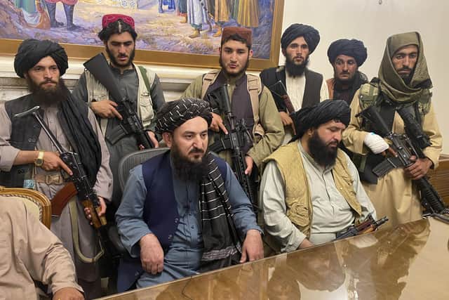Taliban fighters take control of Afghan presidential palace after the Afghan President Ashraf Ghani fled the country, in Kabul, Afghanistan, Sunday, Aug. 15, 2021. (AP Photo/Zabi Karimi).