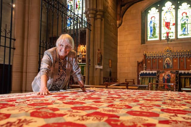 Church Warden Val France, with the quilt she found in a cupboard at St Bartholomew's Church, Marsden, which dates back to 1893.