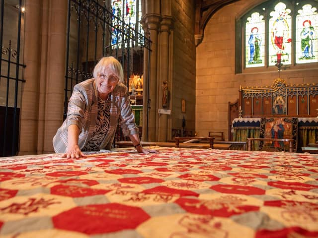 Church Warden Val France, with the quilt she found in a cupboard at St Bartholomew's Church, Marsden, which dates back to 1893.