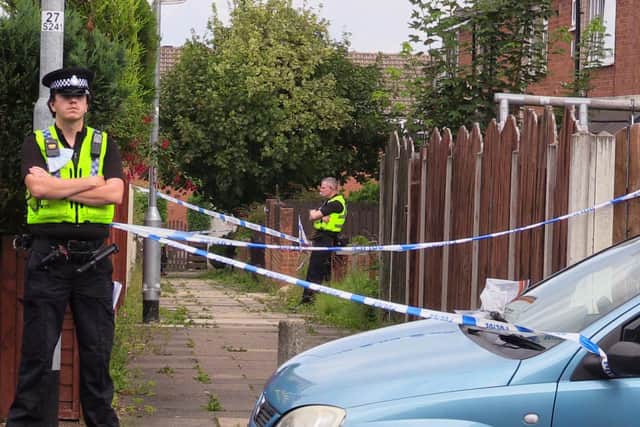 Police guard the scene at Whinmoor, Leeds, after a murder investigation is launched into the death of Eileen Barrott