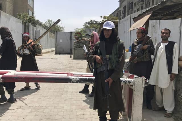 Taliban fighters stand guard at a checkpoint near the US embassy that was previously manned by American troops, in Kabul, Afghanistan, Tuesday, Aug. 17, 2021.