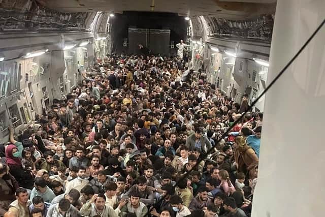 Afghan citizens pack inside a U.S. Air Force C-17 Globemaster III, as they are transported from Hamid Karzai International Airport in Afghanistan.
