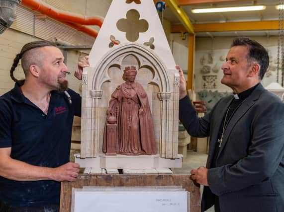 Designer Richard Bossons, one of York MInster's stonemasons, with The Right Revd Dr Jonathan Frost, Dean of York, looking at a scaled replica of what will be the finished statue