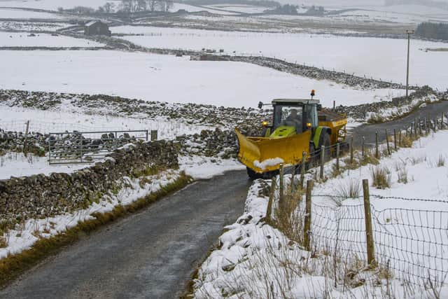Winter scenes with a tractor gritting the Malham Tarn to Settle road in the Yorkshire Dales after sub zero temperatures hit the region in January. Photo: Tony Johnson.