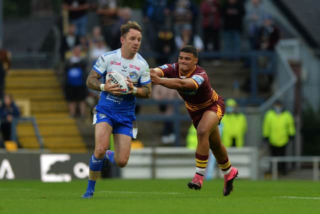Rhinos' Richie Myler is tackled by Huddersfield's Will Pryce.  Picture: Jonathan Gawthorpe