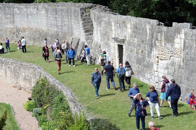 Visitors walk around the curtain wall