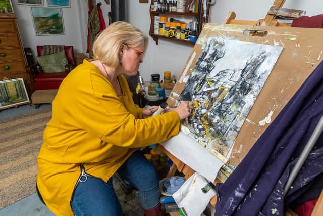 Adele paints using a variety of materials. (James Hardisty).