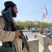 Taliban fighters stand guard at an entrance gate outside the Interior Ministry in Kabul. (Getty Images).