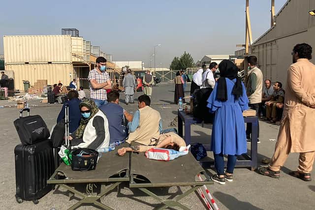 People wait to be evacuated from Afghanistan at the airport in Kabul on August 18, 2021 following the Taliban stunning takeover of the country. (Photo by - / AFP) (Photo by -/AFP via Getty Images).