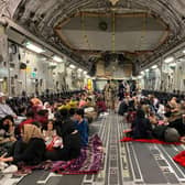 Afghan people sit inside a US military aircraft to leave Afghanistan, at the military airport in the capital Kabul. (Photo: Shakib Rahmani/Getty)