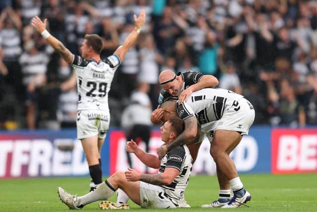 Hull FC's Danny Houghton and Manu Ma'u congratulate Jordan Lane (grounded) after the loose forward charged down Rowan Milnes' last-gasp drop goal attempt to seal a derby win. (JOHN CLIFTON/SWPIX)
